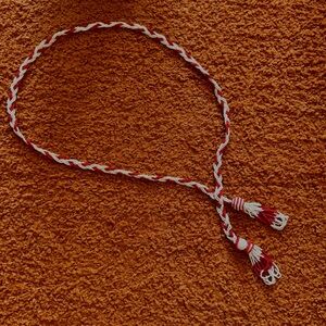 Braided red and white bead belt with tassels